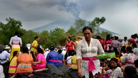 AFP Balinese Hindus take part in a ceremony, where they pray near Mount Agung in hope of preventing a volcanic eruption, in Muntig village