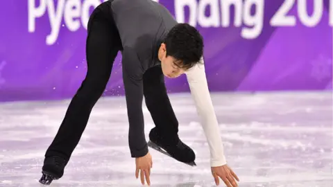 AFP/Getty Images USA's Nathan Chen touches the ice as he skates during the men's short program