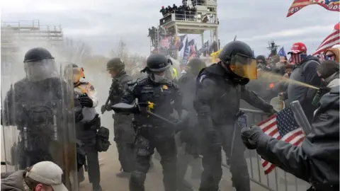 Getty Images Police fight protesters at the Capitol