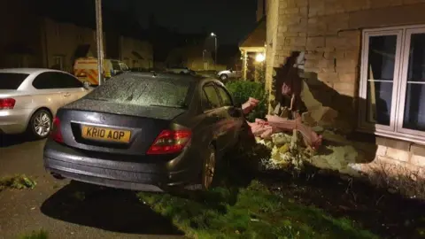 Car crashed into house