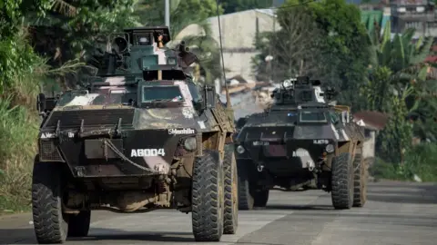 AFP Armoured personnel carriers drive down a village road in Marawi, on the southern island of Mindanao