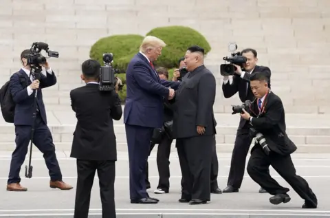 Kevin Lamarque / Reuters President Donald Trump meets with North Korean leader Kim Jong Un at the demilitarized zone separating the two Koreas, 30 June 2019.