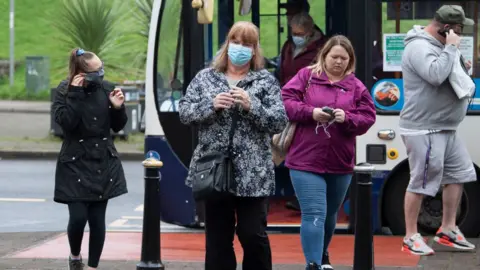 Getty Images People leaving a bus in Caerphilly