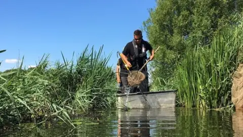Environment Agency Environment Agency workers on the Norfolk Broads
