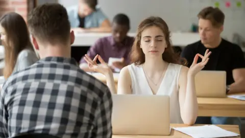 Getty Images A woman meditating (stock image)