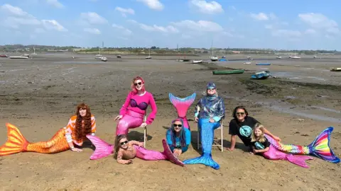 Lucie De Brissac Browning swimmers dressed as mermaids