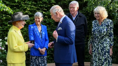 PA Media The King and Queen handing out awards