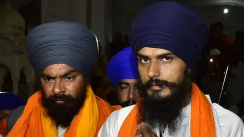 Getty Images Waris Punjab De Chief Amritpal Singh (right) with his close aide Lovepreet Toofan at Golden Temple on 24 February 2023 in Amritsar