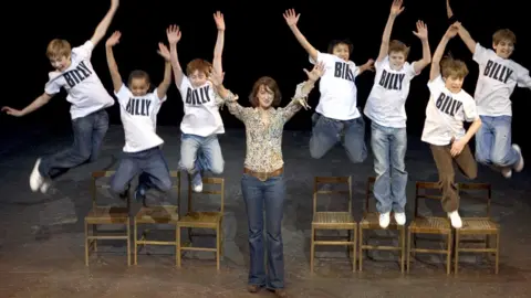 Getty Images Gwynne with the young cast of Billy Elliot the Musical at London's Victoria Palace Theatre in 2006