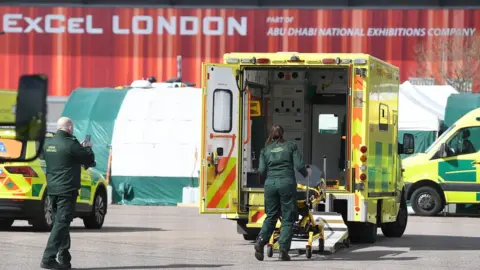 EPA Ambulance workers outside the Nightingale Hospital at the ExCel conference center in London