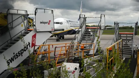 AFP Swissport stairs and other ground equipment by a Ryanair jet at Manchester Airport in May