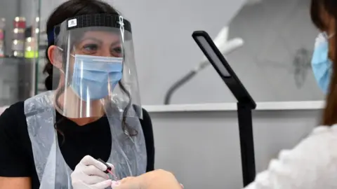 AFP Nail technician wearing a face shield