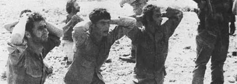 Getty Images Greek Cypriot soldiers surrender to invading Turkish forces, 1974