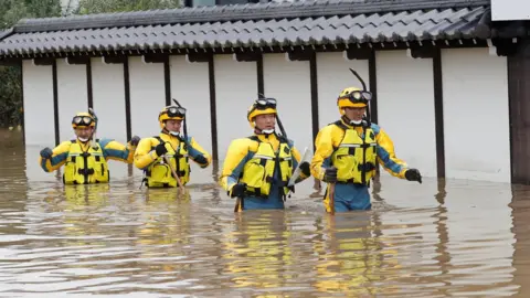 Reuters Police search a flooded area in the aftermath of Typhoon Hagibis,