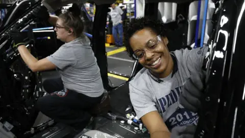 Getty Images Ford workers Jasmine Powers (right) and Cassie Bell (left), install visors in the all-new 2018 Ford Expedition SUV at the Ford Kentucky Truck Plant October 27, 2017 in Louisville, Kentucky.