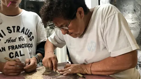 Blanquita Monroy working on a woodcut