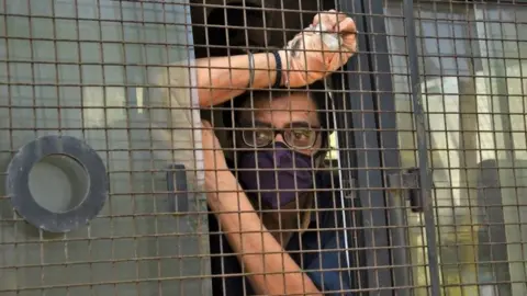 Reuters Arnab Goswami, one of India"s top TV news anchors, sits inside a police van outside a court after he was arrested, at Alibaug town in the western state of Maharashtra, India, November 4, 2020.