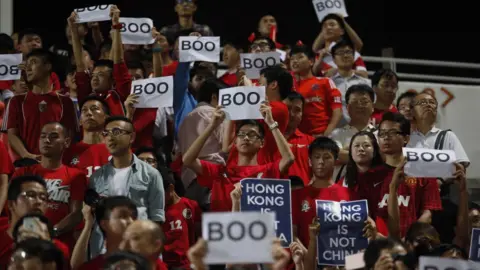 AFP Hong Kong fans hold up signs that read 'Boo' while the national anthem was being played during a world cup qualifier at Mong Kok stadium in Hong Kong on November 17, 2015.