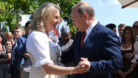 Reuters Austria's former foreign minister Karin Kneissl dances with Russia's President Vladimir Putin at her wedding in 2018.