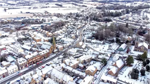 PA Media Snow fall in Biggar in South Lanarkshire.