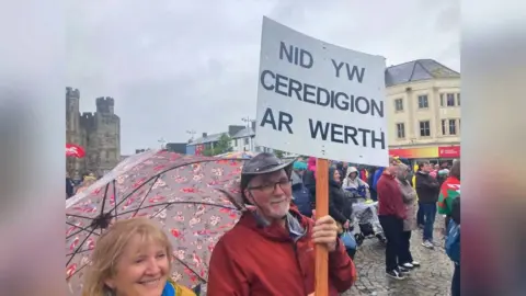 Two protestors holding a placard