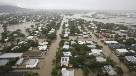 EPA An aerial picture of Townsville's houses half-submerged in flood waters