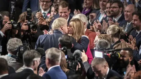 PA Media Prime Minister Boris Johnson with partner Carrie Symonds, they have announced that they are expecting a baby in the early summer and that they have got engaged