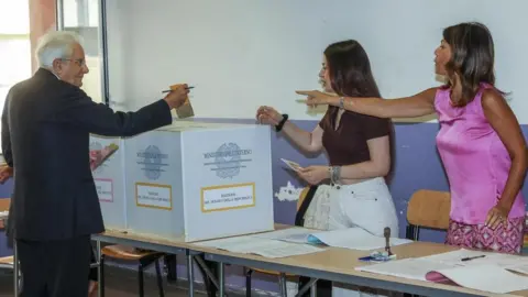 EPA-EFE/REX/Shutterstock Italian President Sergio Mattarella (L) casts his ballot at a polling station during voting for the general election, in Palermo, Sicily