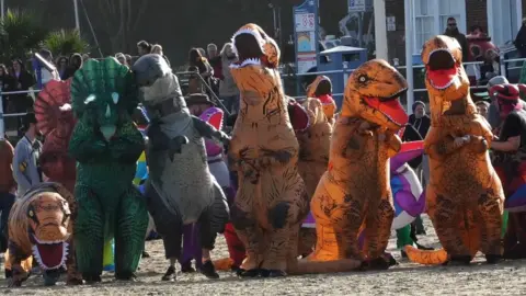 We Are Weymouth Dinosaurs on a beach