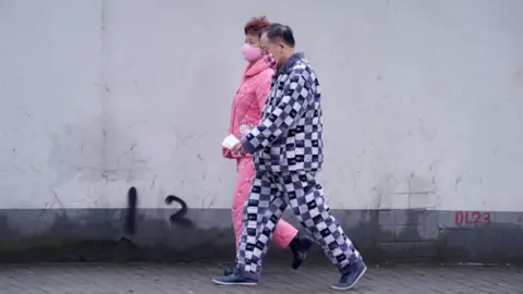 Reuters People in Beijing stepped out in their pyjamas during China's lockdown