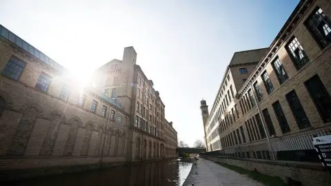 Getty Images Saltaire's mill on the banks of the Aire