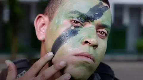 Soldier applying face paint