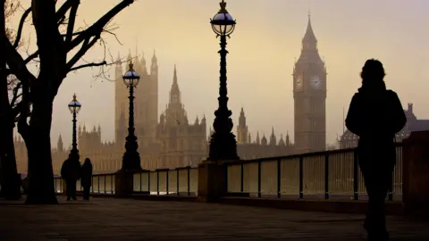 Big Ben and the Houses Of Parliament seen on a foggy morning from the other side of the river