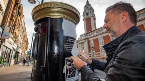 PA Media A black postbox