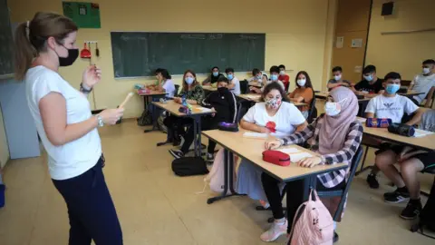 Reuters Pupils and a teacher wearing face masks at a school in Bonn, Germany