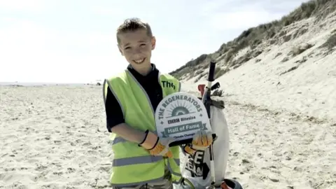 BBC Theo with his BBC Regenerator award on Hemsby beach