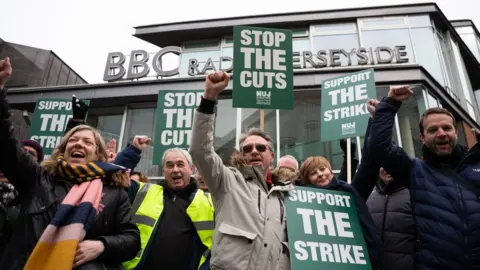 EPA Striking BBC Local staff picket outside BBC Radio Merseyside in Liverpool, Britain, 15 March 2023. BBC Local workers in the National Union of Journalists (NUJ) have timed their strike to affect coverage of the Chancellor's Spring Budget in a row over reductions of local radio services and plans for stations to share programming on weekdays.