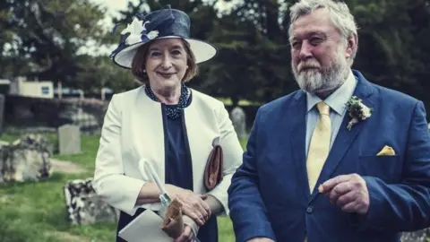 Gloucestershire Police Valerie and Clive Warrington smiling at a wedding