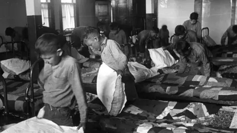 Getty Images 1950: North American Indian children in their dormitory at a Canadian boarding school. (Photo by Hulton Archive/Getty Images)