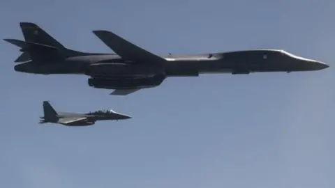 AFP A US Air Force B-1B Lancer, flanked by Republic of Korea Air Force fighter, taking part in a show of force exercise in response to North Korean ballistic missile tests (18 September 2017)