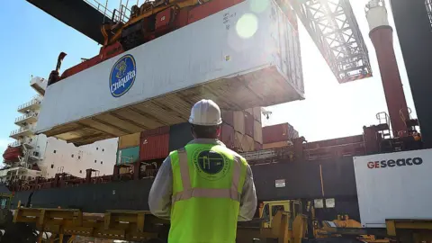 Getty Images Shipping containers are offloaded from a cargo ship at Port Everglades in Fort Lauderdale, Florida.