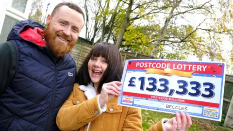 People's Postcode Lottery Zoe and Dan Mowday with their winning cheque