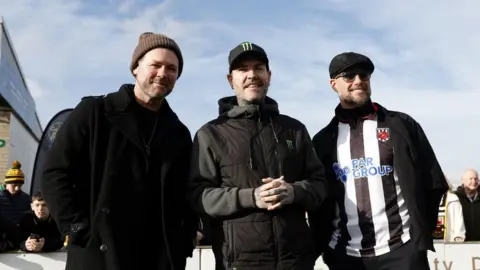 PA Media Brian McFadden of Westlife with Shane Lynch and Keith Duffy of Boyzone