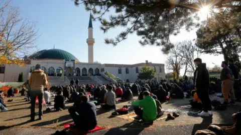 Reuters Muslims pray for victims of a gun attack during their Friday prayer, outside the mosque in Vienna, Austria November 6, 2020