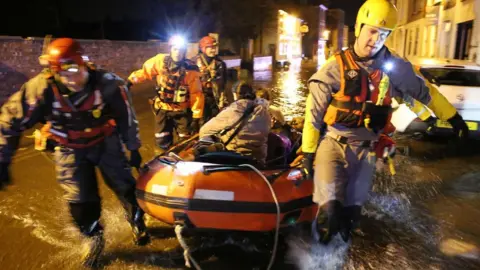 Getty Images Woman being rescued in lifeboat