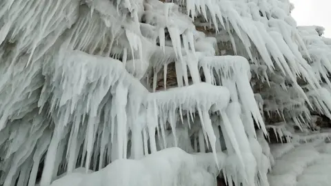 Oleg Boldyrev close up of ice sculptures hanging off a cliff