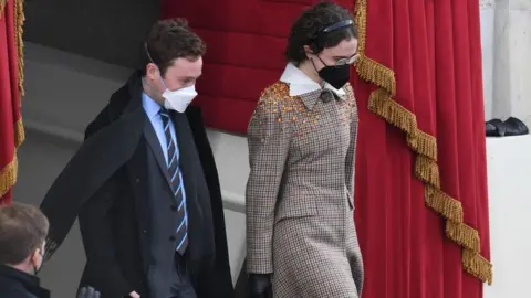 AFP via Getty Images Stepchildren of Vice President-Elect Kamala Harris Cole Emhoff and Ella Emhoff arrive for the inauguration