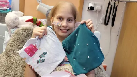 Family picture Teenager in hospital bed with gifts