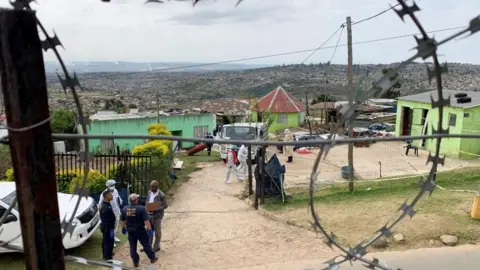 Reuters The exterior of the homestead with police and medical officials outside Pietermaritzburg, South Africa April 21, 2023.