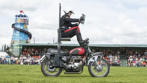 PA A member of the White Helmets, the Royal Signals Motorcycle Display Team